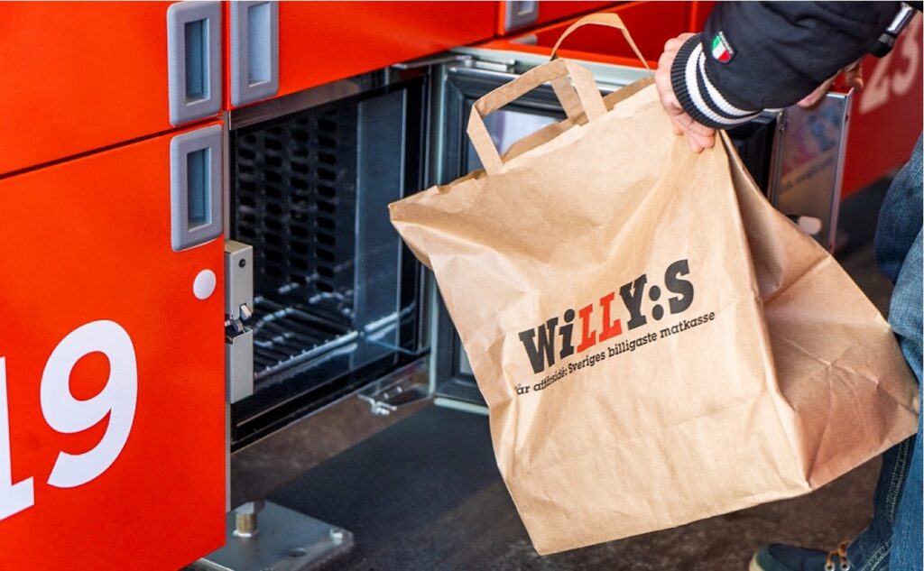 Someone retrieving a shopping bag from a grocery locker