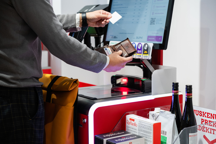 person using a self checkout terminal