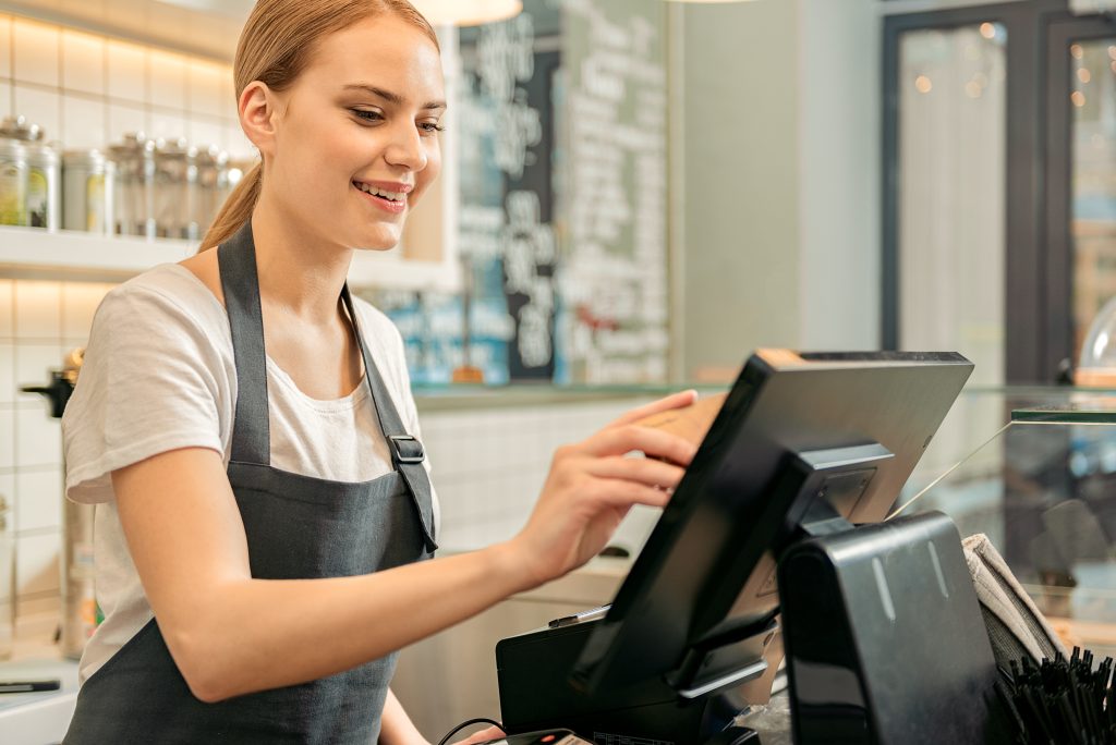 Store employee - shop assistant- using POS terminal